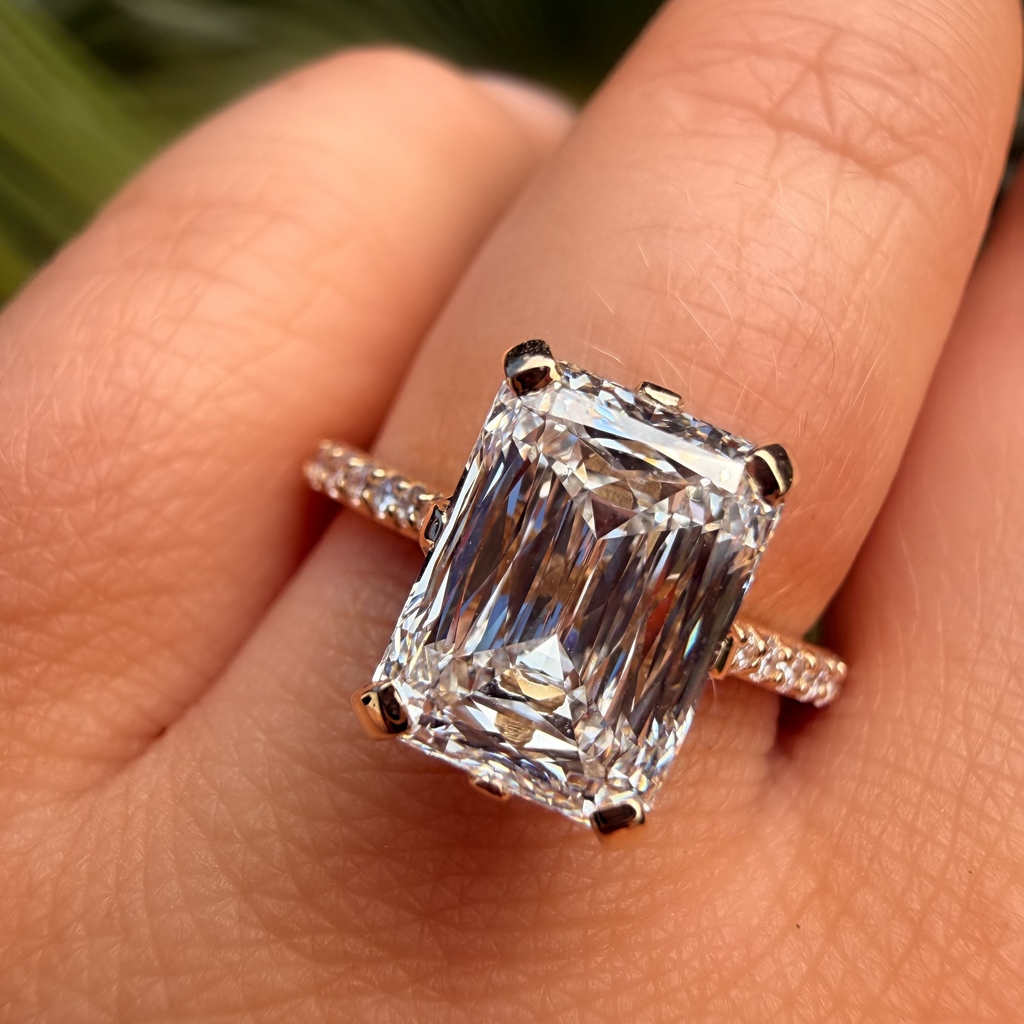 Diamond ring on a finger with a blurred natural background