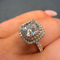 Diamond ring on a finger with a blurred background