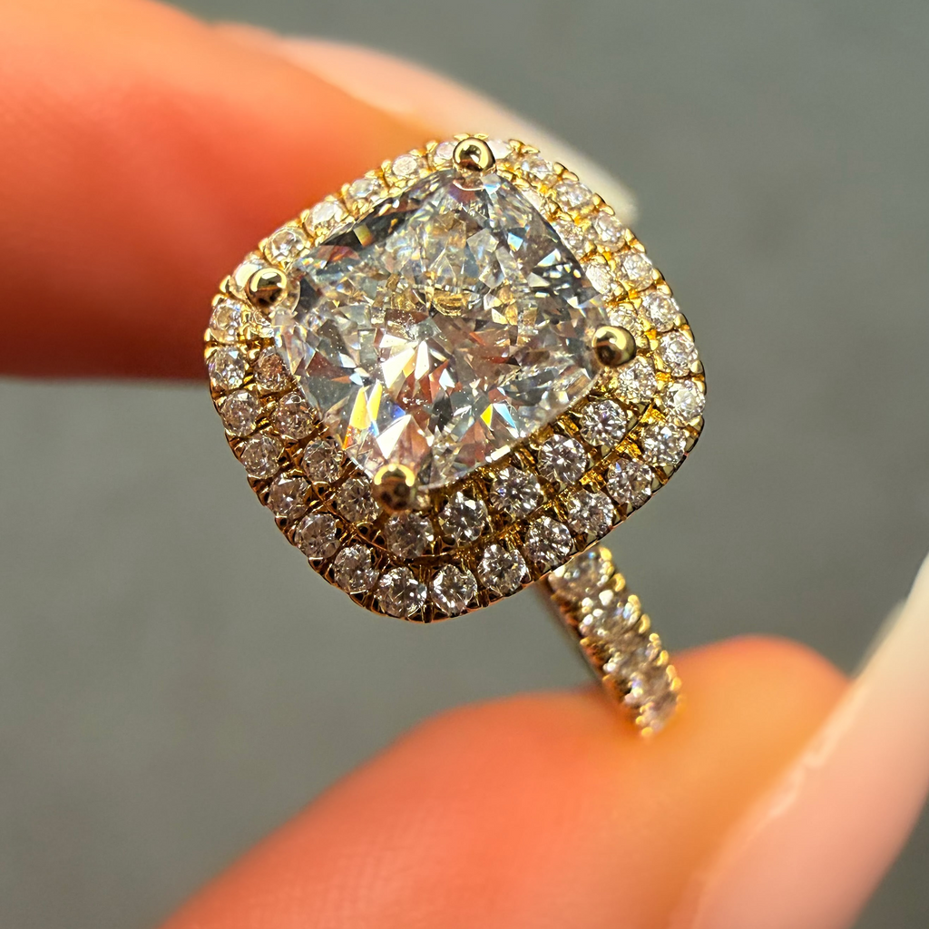 Diamond ring held between fingers with a blurred background