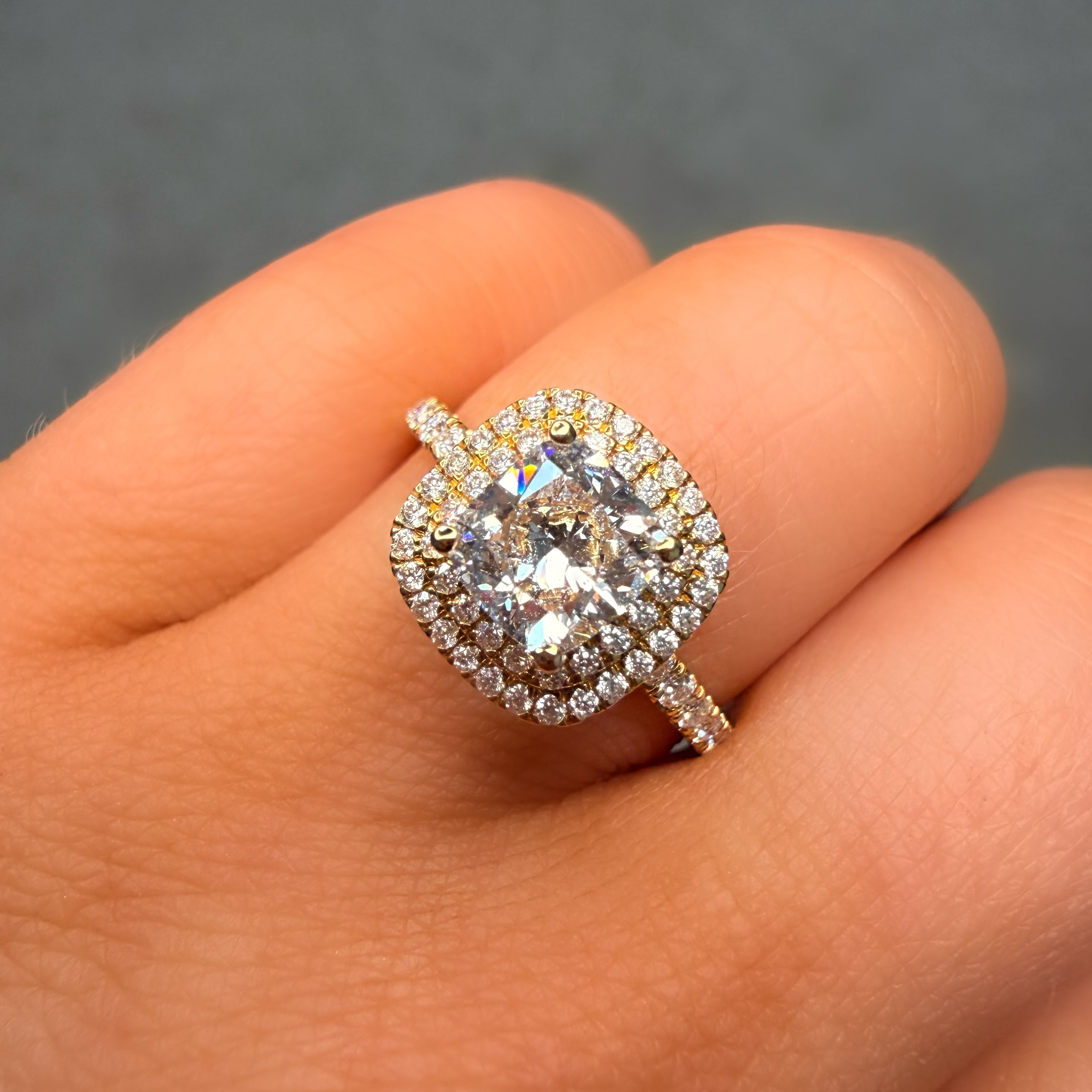 Diamond ring on a hand with a dark background
