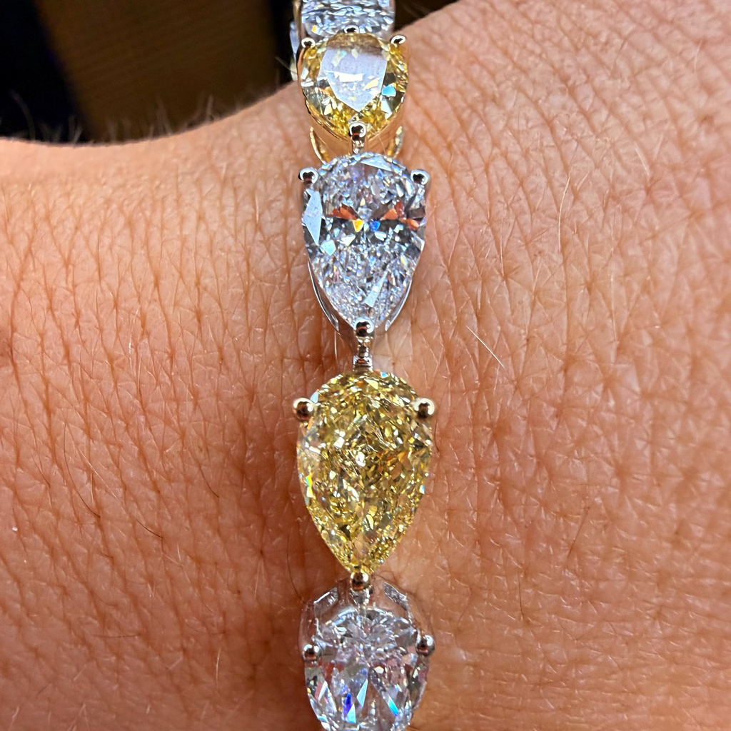 Diamond bracelet on a wrist with a neutral background