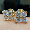 Gold earrings with clear gemstones on a hand