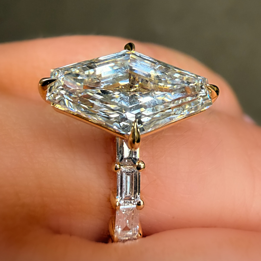 Gold ring with a large diamond on a finger