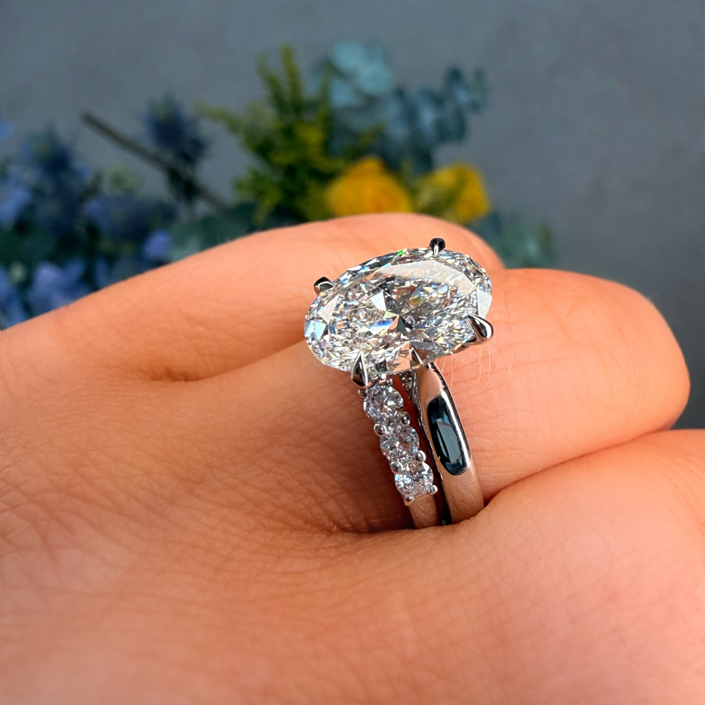Diamond ring on a hand with a blurred natural background
