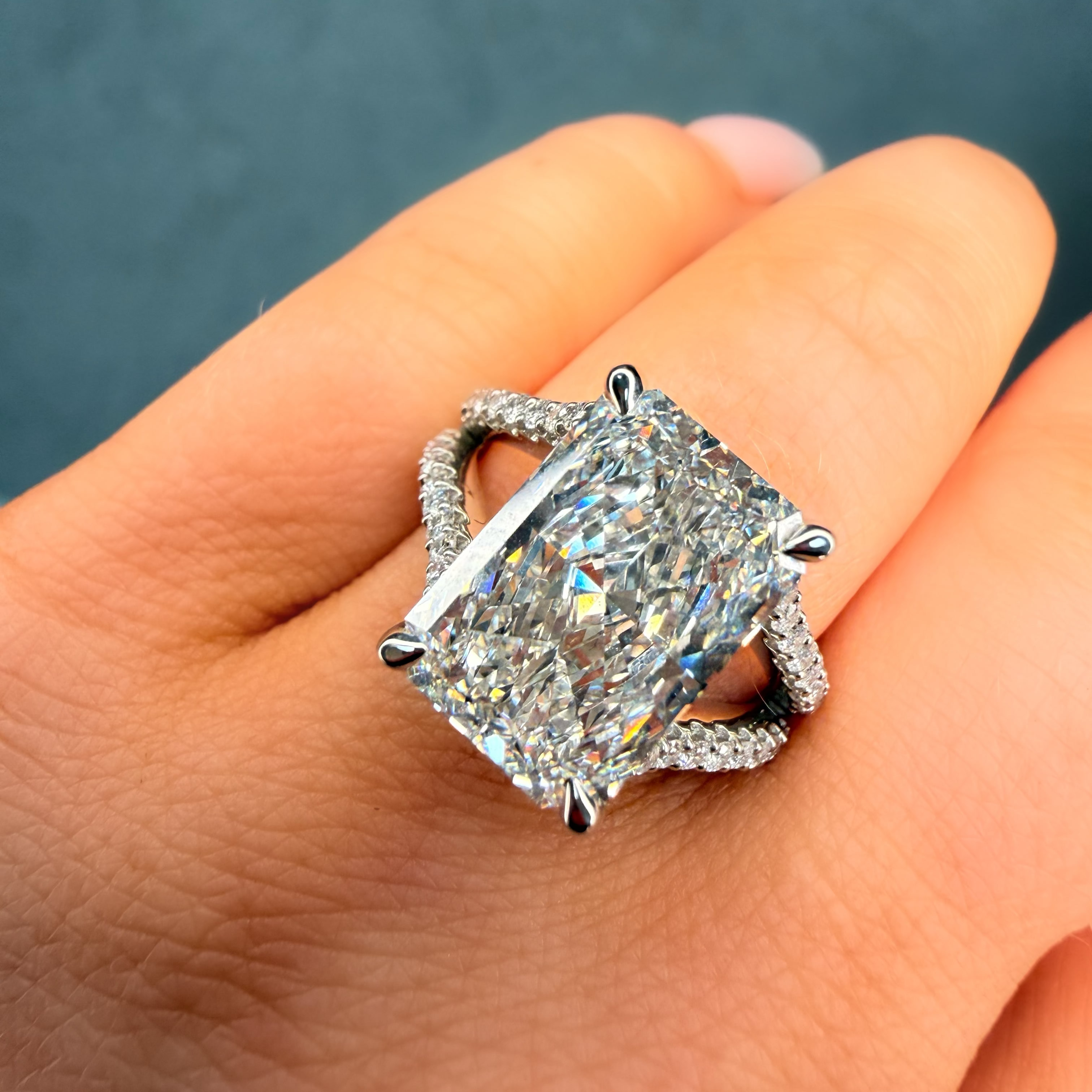 Diamond ring on a hand with a dark background