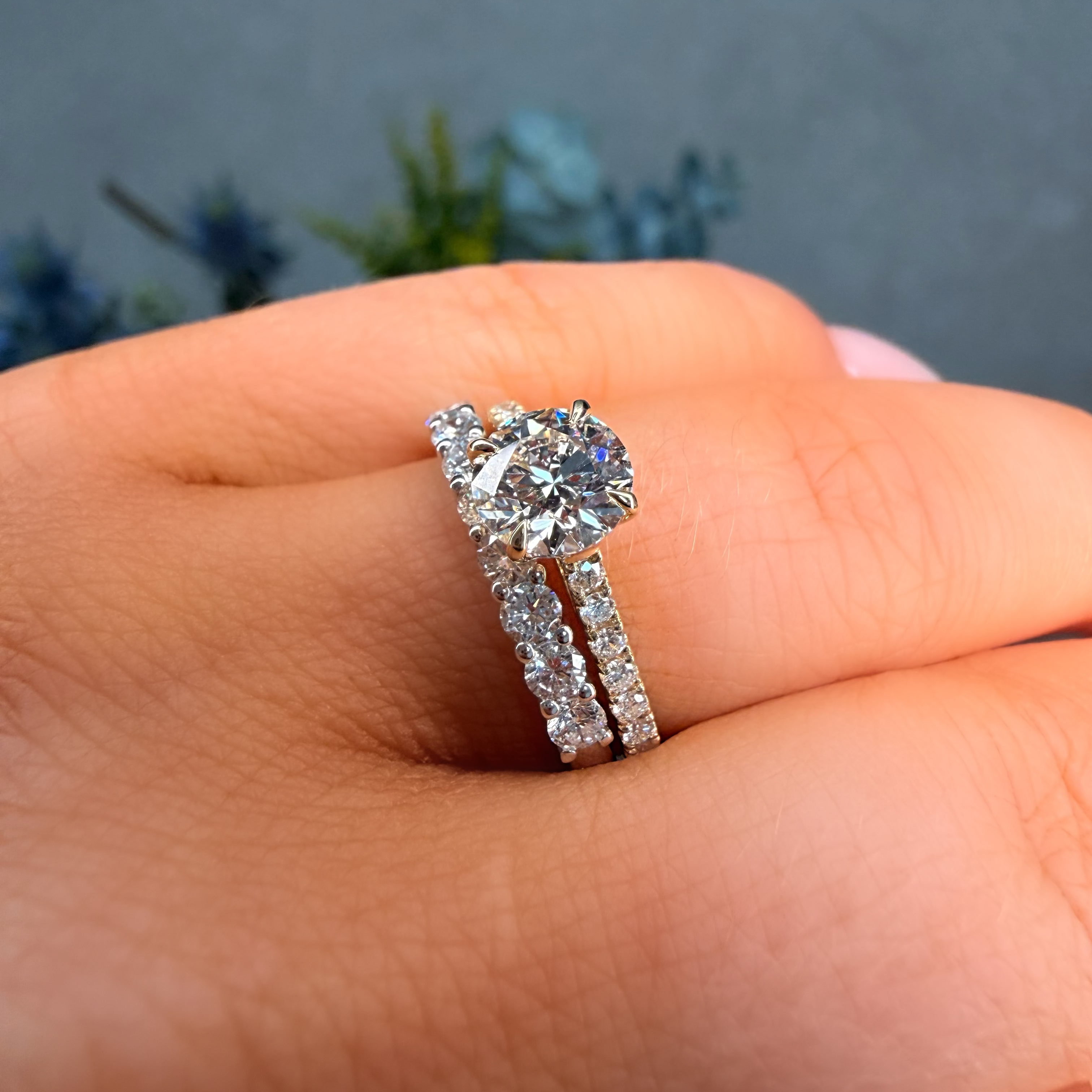 Diamond ring on a hand with a blurred natural background