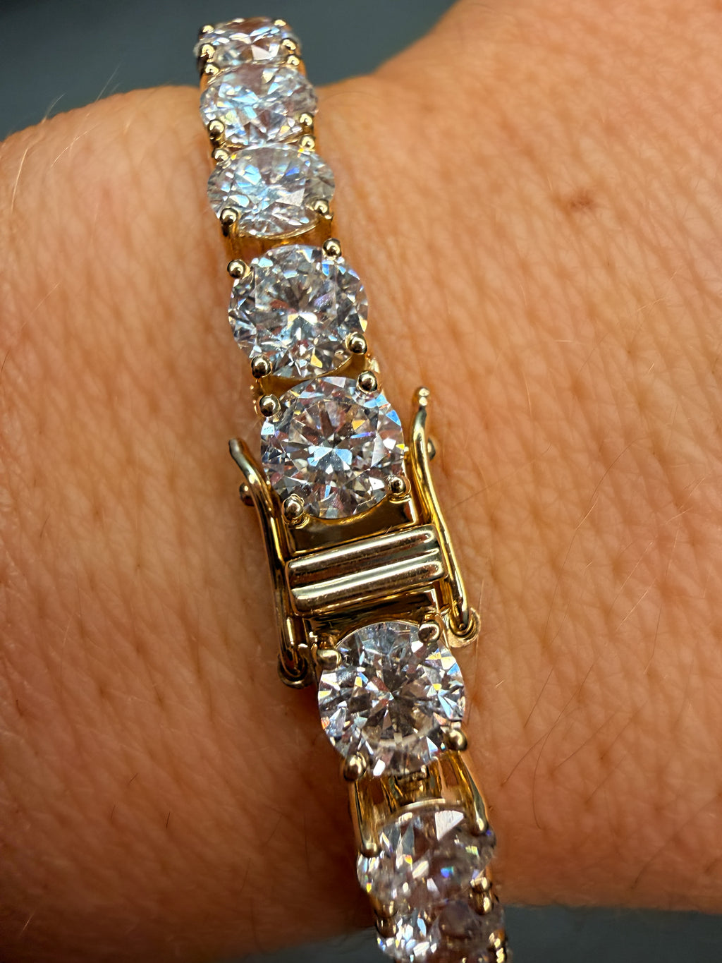 Gold bracelet with diamond stones on a wrist