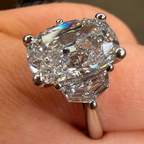 Diamond ring on a finger with a blurred background