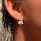 Close-up of an ear wearing a diamond earring with a blurred background