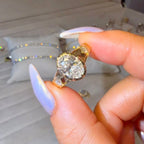 Gold ring with a large diamond held by a hand in front of a Labking Jewellers box.