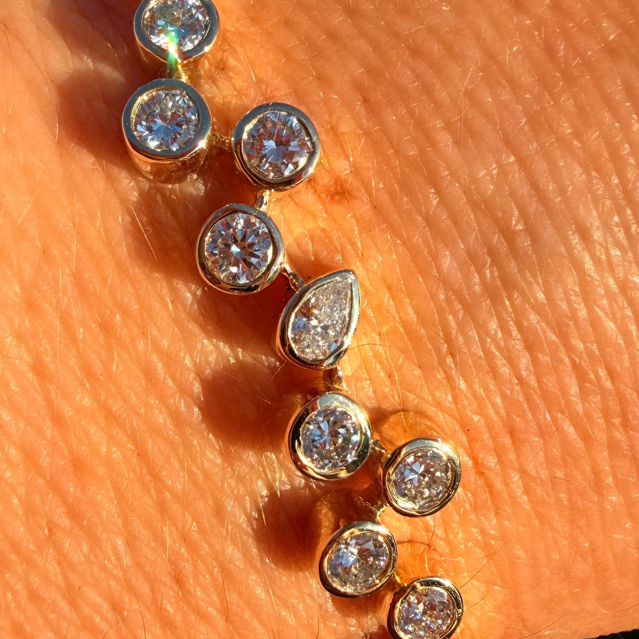 Gold bracelet with diamond beads on a hand