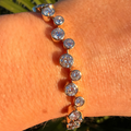 Bracelet with clear stones on a wrist against a natural background