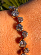 Gold bracelet with clear stones on a person's wrist
