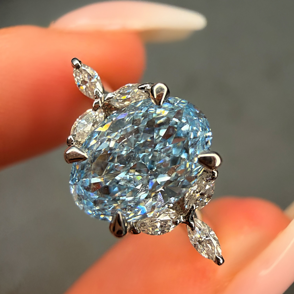 Close-up of a diamond ring held between fingers with a blurred background