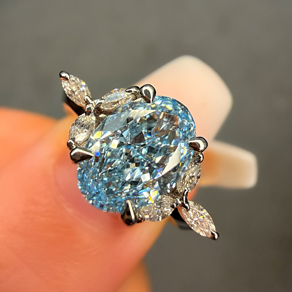 Blue diamond ring held between fingers against a neutral background