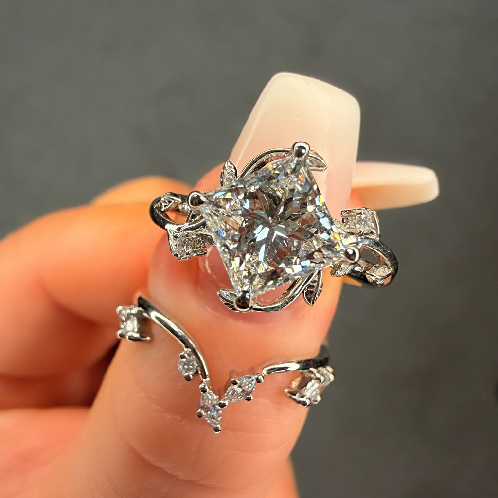 Silver ring with a large diamond on a hand against a dark background