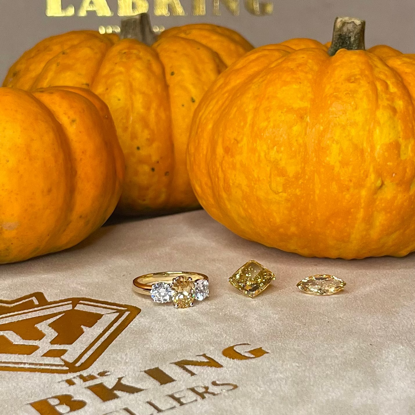 Pumpkins and jewelry on a surface with 'Lab King Jewellers' branding.