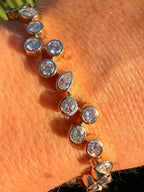 Gold bracelet with clear stones on a person's wrist