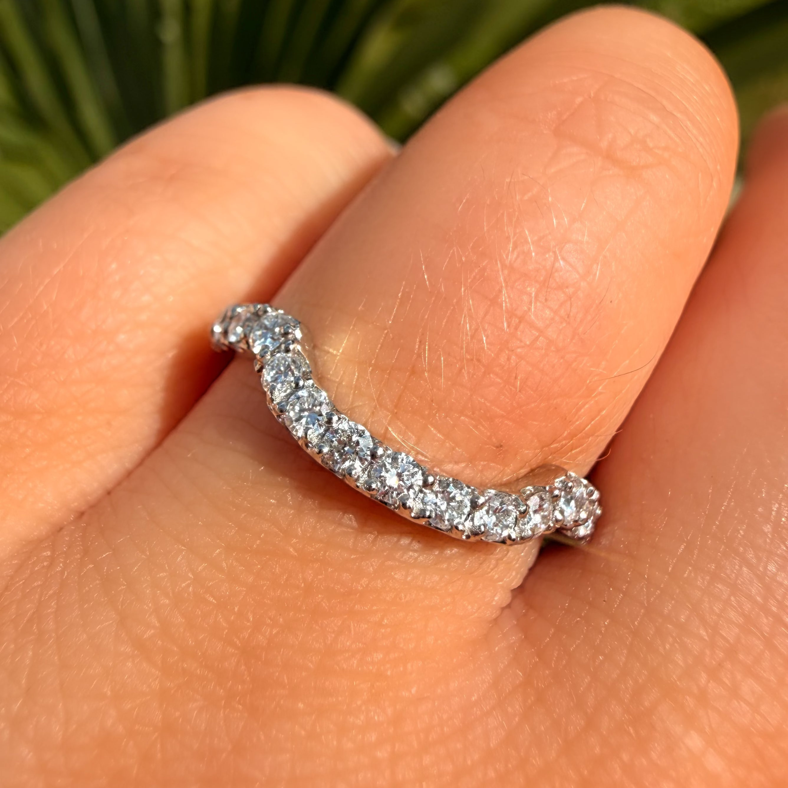 Silver ring with small diamonds on a finger