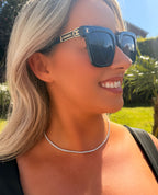 Woman wearing Chanel sunglasses with a blurred background